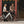 Woman walking a white Batribike Route S along the pavement next to a man with a black Route X