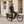 Man in a helmet standing astride a black Batribike Route X electric bike on a cobbled street