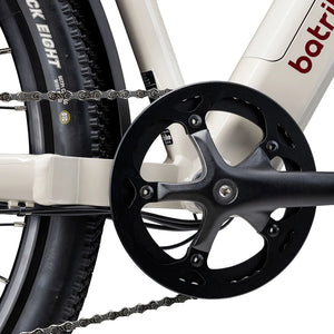 Close up of the chainring guard and crank on the cream Batribike SUV S with a Kenda tyre behind