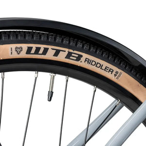 Close up of a WTB Riddler 45 700c tan wall tyre fitted to the Batribike Tour S grey alloy wheel.