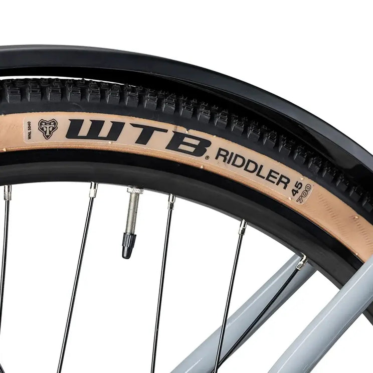 Close up of a WTB Riddler 45 700c tan wall tyre fitted to the Batribike Tour S grey alloy wheel.