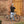 Man standing beside a grey Batribike Tour X electric bike outside a brick archway.