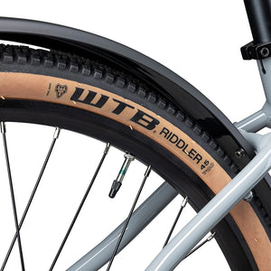 Close up of the WTB Riddler 45 tan wall tyre under the mudguard of the grey Batribike Tour X