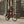 Man wearing a helmet riding a red Batribike Trail electric mountain bike along a cobbled city street.