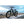 Big Game Bikes Buffalo Mountain electric bike positioned on a seafront ledge with ocean and cloudy sky in the background.