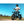 Man standing beside the Big Game Bikes Impala electric bike on a dirt trail, wearing a helmet and ready for off-road riding.