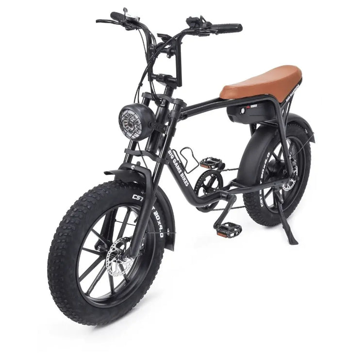 Angled front view of the Big Game Bikes Warthog cruiser e-bike showing headlight, wide tyres, and side-mounted kickstand.