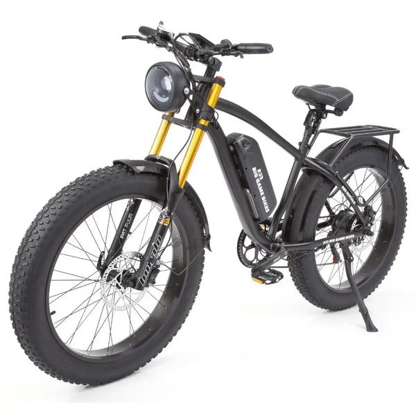 Angled front view of the Big Game Bikes Buffalo Alpha Plus e-bike with gold suspension forks, fat tyres, and integrated headlight.