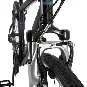 Close-up of the V-brake caliper and suspension fork detail on the front wheel of the Explorer 1.0.