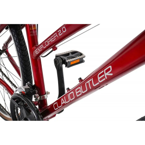 Detailed shot of the CLAUD BUTLER and EXPLORER 2.0 decals on the downtube of the red hybrid bike.