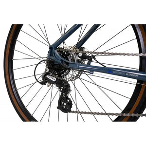 Close-up of the Shimano rear derailleur and 7-speed cassette on the red Explorer 3.0.