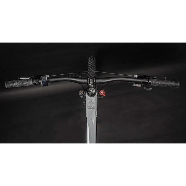 Top-down view of Claud Butler Ridge 1.0 electric mountain bike handlebars with LCD display and textured grips.