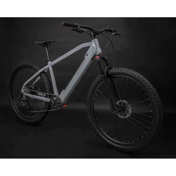 Angled view of the Claud Butler Ridge 1.0 electric mountain bike in matte grey with thick off-road tyres and front suspension.
