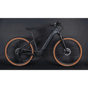 Full side profile of the Claud Butler Wrath 2.0 Cues electric mountain bike, showing the integrated battery, black frame, and tan wall tyres designed for off-road riding.