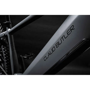 Close-up of the grey alloy downtube on the 2025 Claud Butler Wrath 1.0 electric mountain bike, featuring the bold black brand logo and integrated battery compartment.