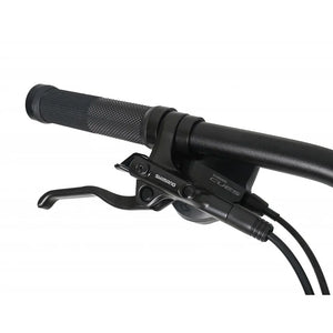 Detail view of the handlebar controls on the Claud Butler Wrath 1.0, explicitly showcasing the new Shimano Cues gear shifter and hydraulic brake lever for precise off-road handling.