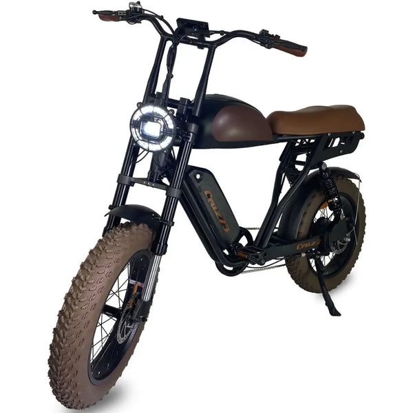 Front angle view of the Cruz73 Mariner Retro Special Edition electric bike with round headlight and brown saddle.