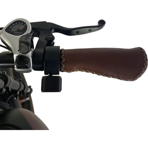 Close-up of the Cruz73 Mariner Retro Special Edition electric bike gear shifter and stitched brown handle grip.