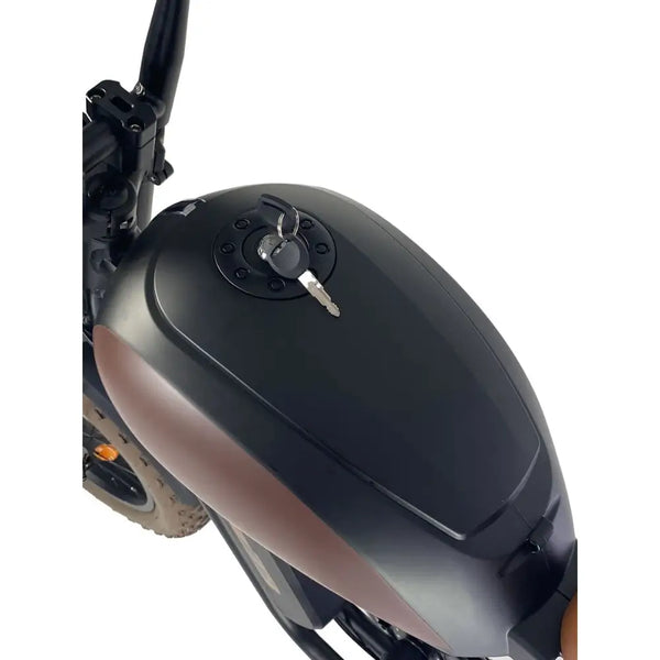 Close-up of the Cruz73 Mariner Retro Special Edition electric bike tank with ignition key inserted.