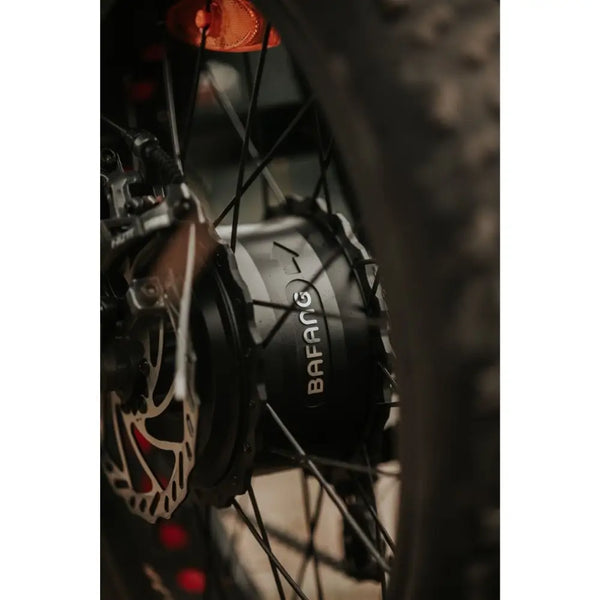 Close-up of the Bafang motor on the Cruz73 Pro Retro Fat Tyre Electric Bike 250W, showing the rear wheel and disc brake.