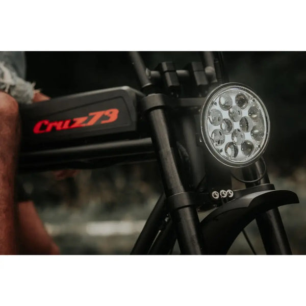 Front view of the Cruz73 Pro Retro Fat Tyre Electric Bike 250W, focusing on the LED headlight and frame design.