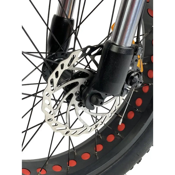 Close-up of the Cruz73 Unlimited Retro Fat Tyre 750W electric bike front wheel disc brake system.