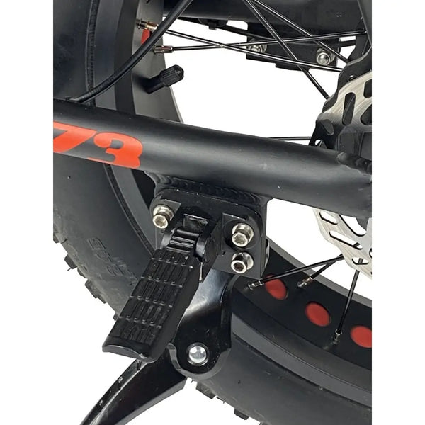 Close-up of the folding rear footpeg on the Cruz73 Unlimited Retro Fat Tyre Electric Bike 750W in black.