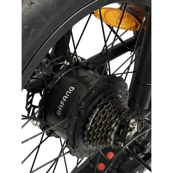 Close-up of the Cruz73 Unlimited Retro Fat Tyre 750W electric bike rear hub motor with Shimano gear cassette.