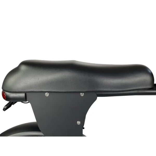 Side view of the wide cushioned seat on the Cruz73 Unlimited Retro Fat Tyre Electric Bike with rear light.