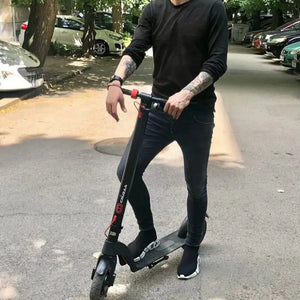 A rider pausing with the Cruzaa Commuta 350W on a quiet residential road.