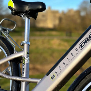 Close-up of the silver seat tube on the Dallingridge Harlow e-bike, showing the adjustable saddle height lever and model branding.