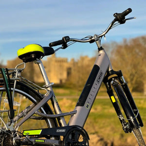 Angled side view of the silver Dallingridge Harlow step-through electric bike highlighting the integrated battery and suspension fork.