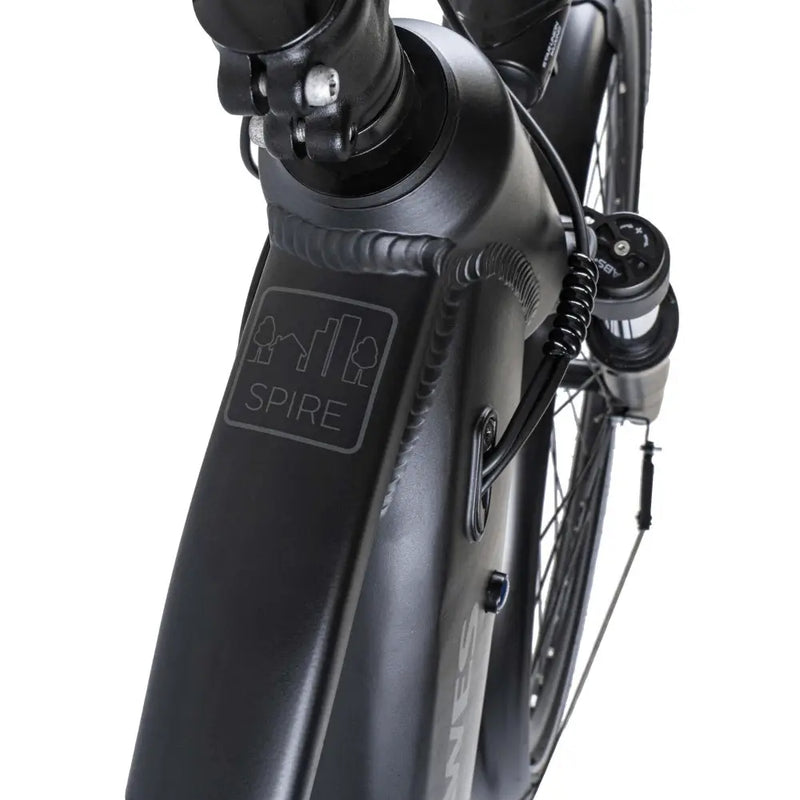 Close-up of the Dawes Spire 1.0 Crossbar electric hybrid bike frame showing the Spire logo near the handlebar stem.