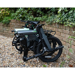 Two E-Go CarbonLite electric bikes folded and standing upright to demonstrate compact size.