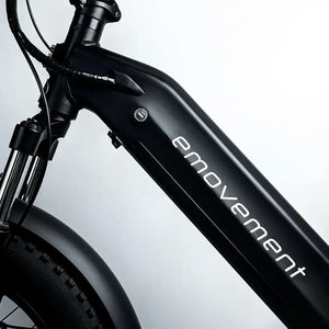 Close-up of a black electric bike with 'emovement' branding on a light gray background