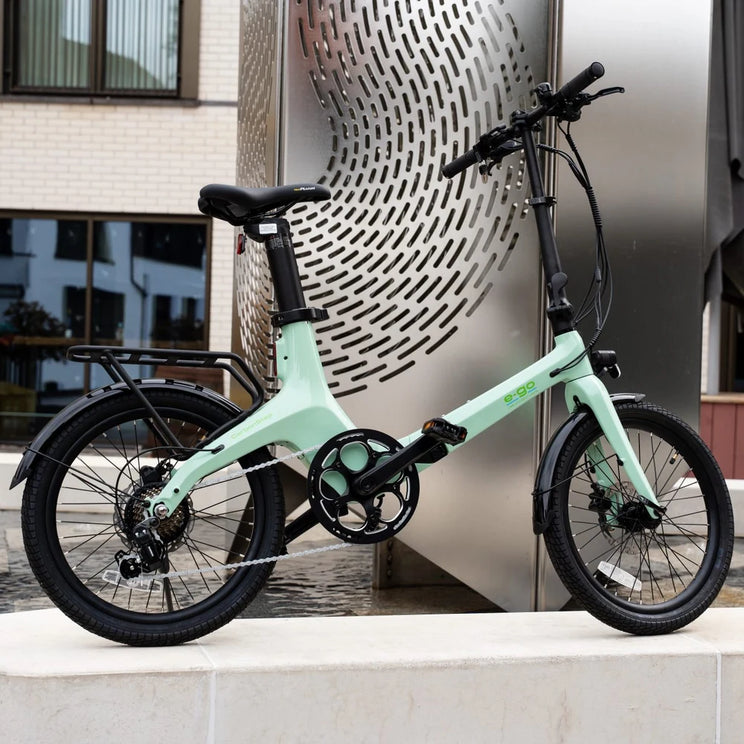 E-Go CarbonStep in Duck Egg with rear rack, parked in a town centre