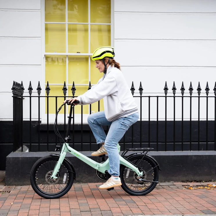 Rider on the E-Go CarbonStep in Duck Egg, showing the easy step-through frame