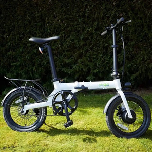 Side view of the white E-Go Lite folding e-bike on a grassy lawn, highlighting its compact geometry and 250W motor hidden in the front hub.