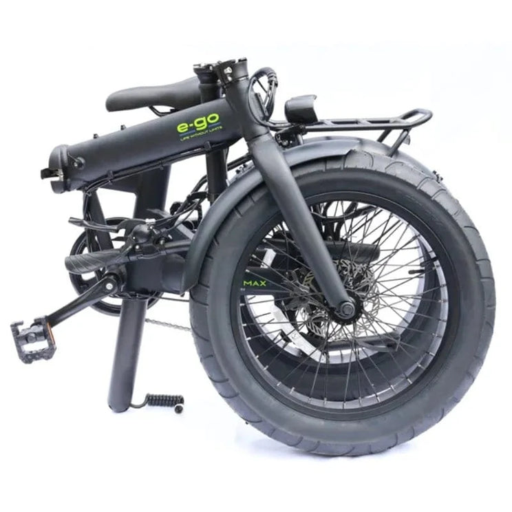 Side view of the E-Go Max+ electric bike in satin black, fully folded into its compact form showing the massive 4.25-inch fat tyres and seat post battery integration.