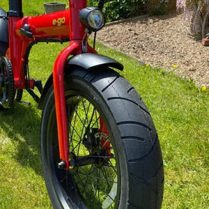 Front view of the red E-Go Max+ e-bike, featuring wide 4.25-inch fat tyres for all-terrain stability.