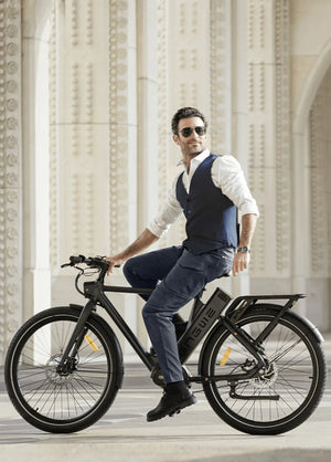 Man in formal attire riding an electric bike in a classical architecture setting
