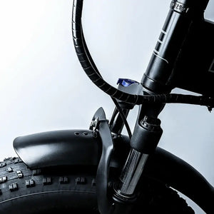 Close-up of the front suspension fork and large fat tyre on the EMovement Panther V4.2.