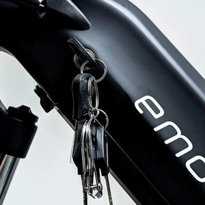 Keys inserted in battery lock of E Movement Raven electric bike.