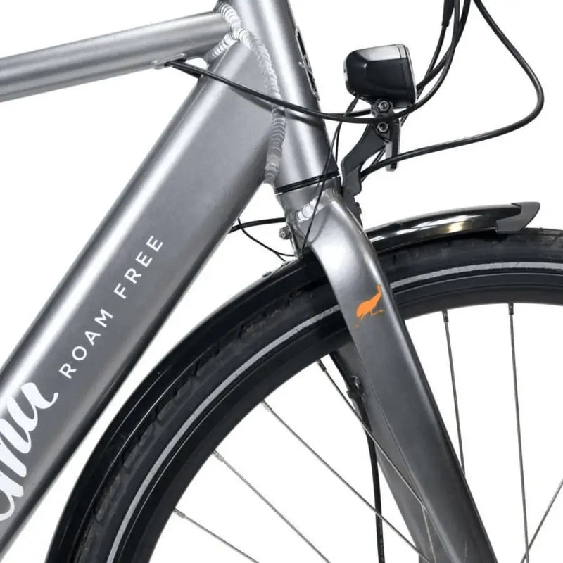 Detail shot of the front suspension fork, integrated front light, and Emu logo on the silver electric bike.