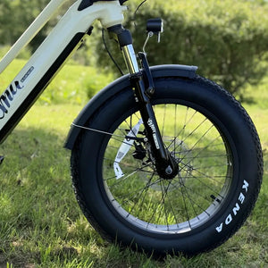 Front suspension fork and Kenda fat tyre close up on the cream Emu Longtail cargo e-bike.