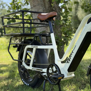 Side view of cream Emu Longtail with brown leather saddle and black tubular cargo rack.