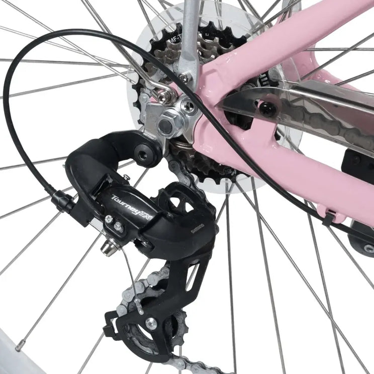 Detail shot of the Shimano Tourney TX rear derailleur and 7-speed drivetrain on the pink Emu Roam electric bike.