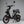 Side view of the Eskuta SX-250 Series 4 moped-style electric bike in black, showing front disc brake and dual mirrors.