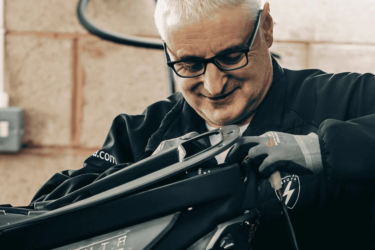 Eskuta technician preparing an SX-250 in the workshop before a white glove handover