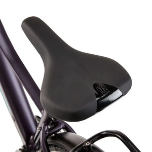 Close-up of the ergonomic comfort saddle on the EZEGO Commute Int, featuring the branded logo and designed for long-distance urban riding.
